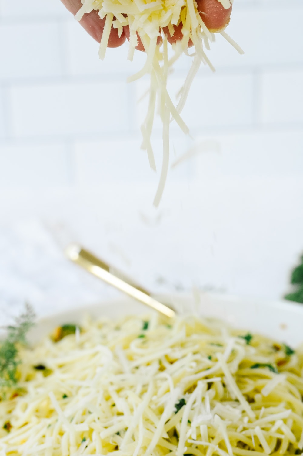 Adding parmesan cheese to pasta