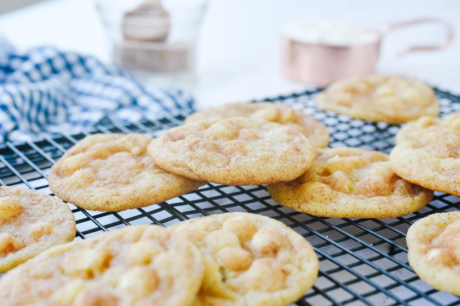 White chocolate chip snickerdoodles on a rack