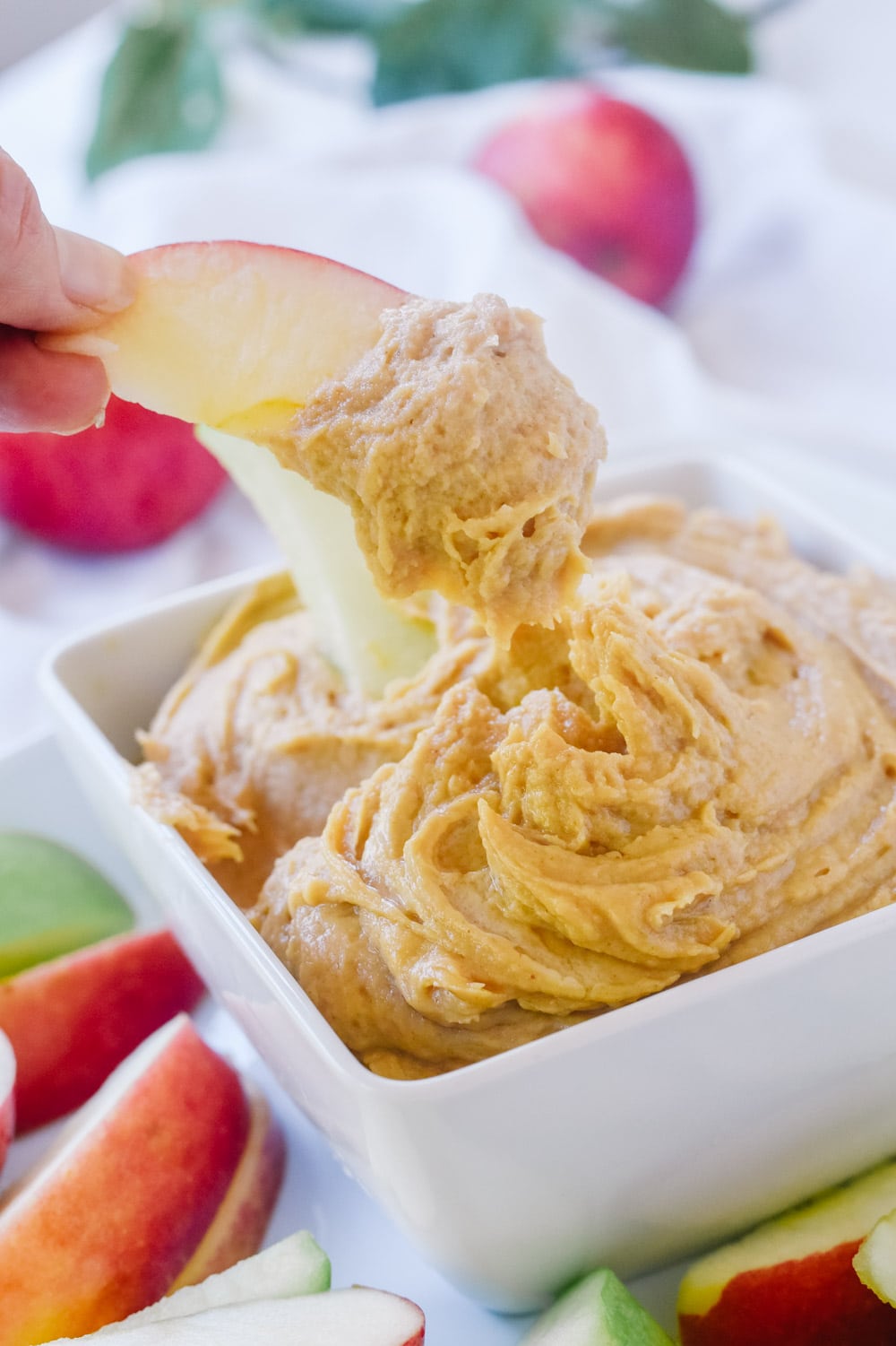 apple dipping in peanut butter dip