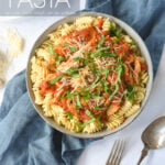 chicken and tomato pasta with basil on top