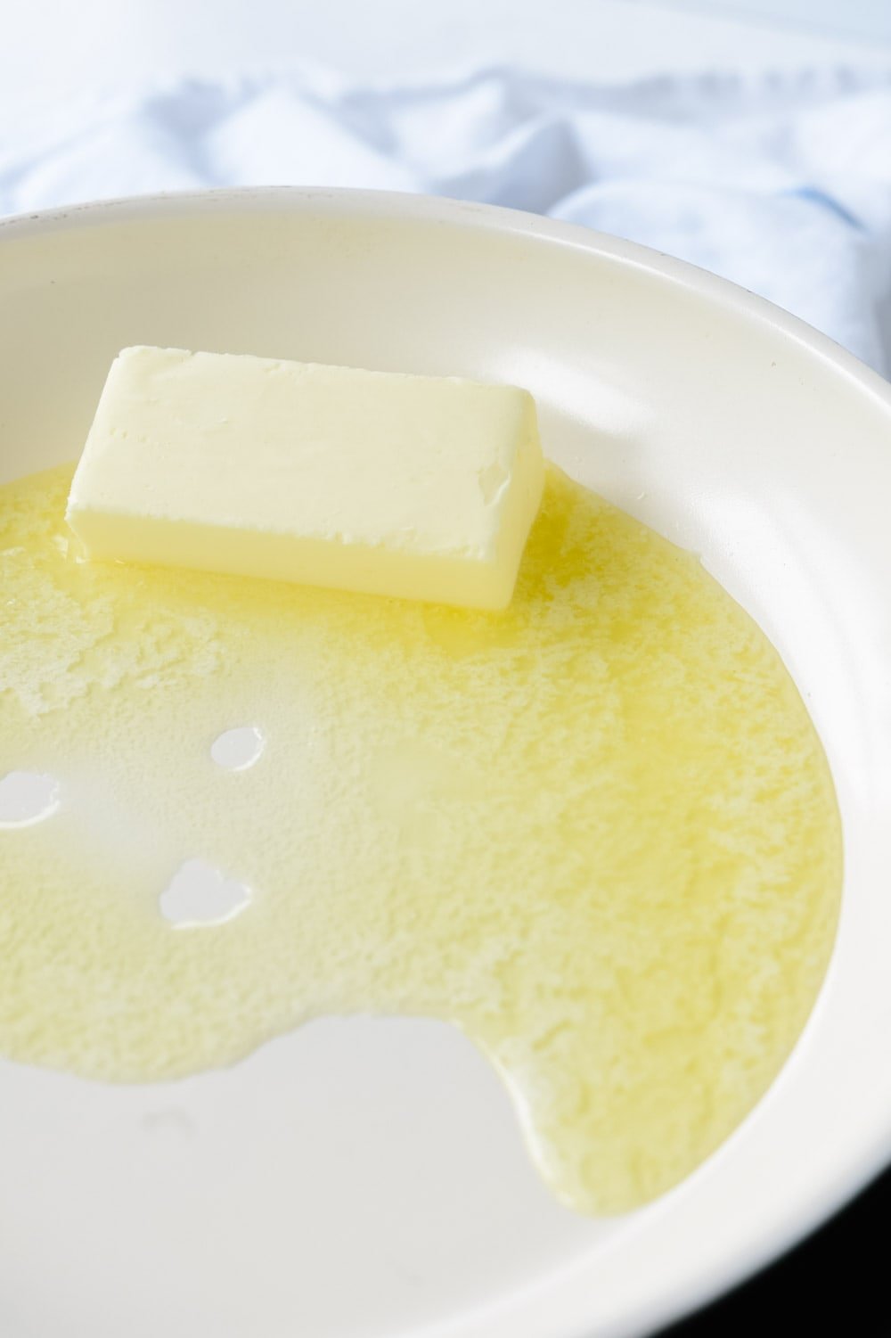 Melting butter in pan.