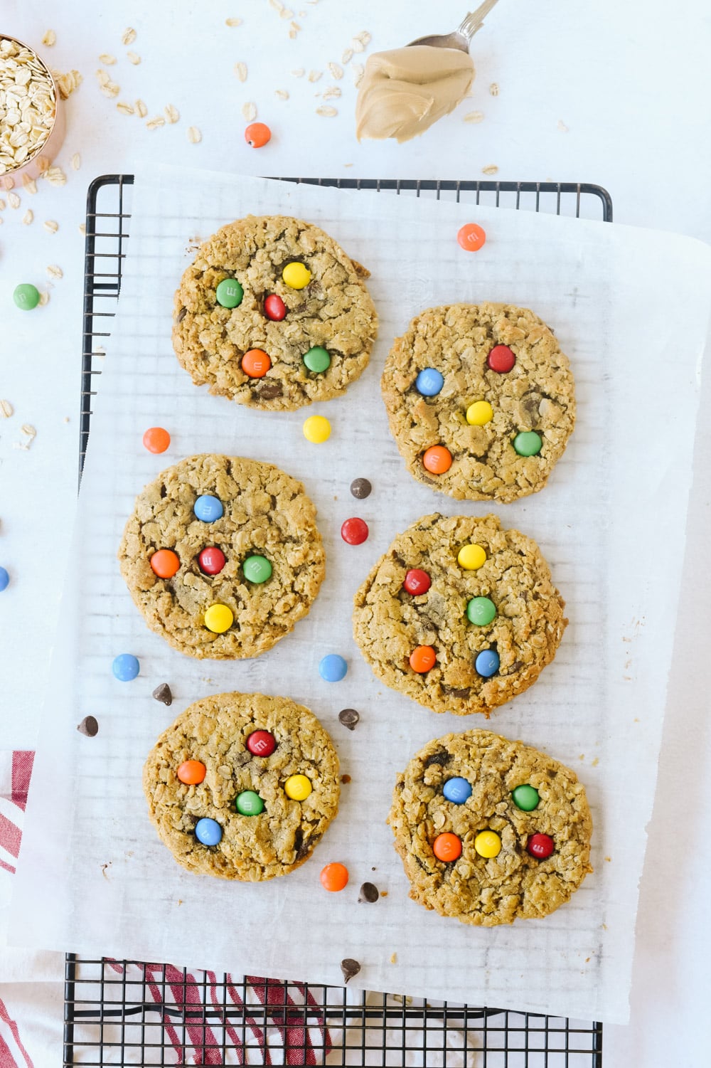 Six Monster cookies on a cooling rack