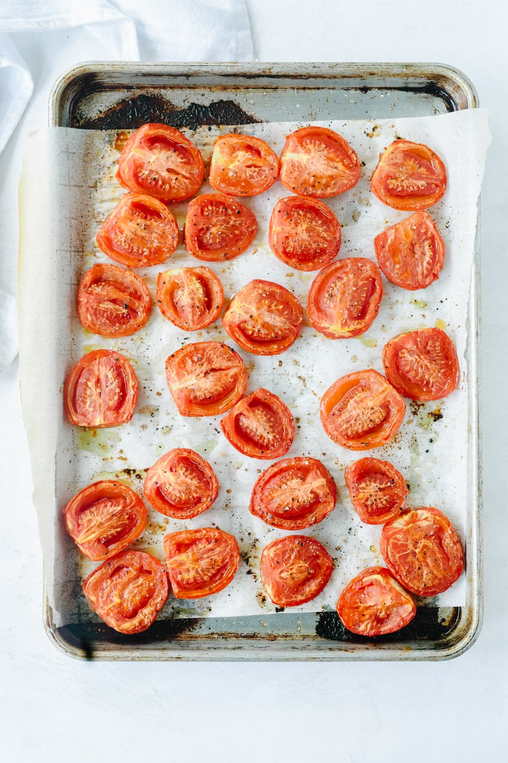 Sliced tomatoes on parchment paper