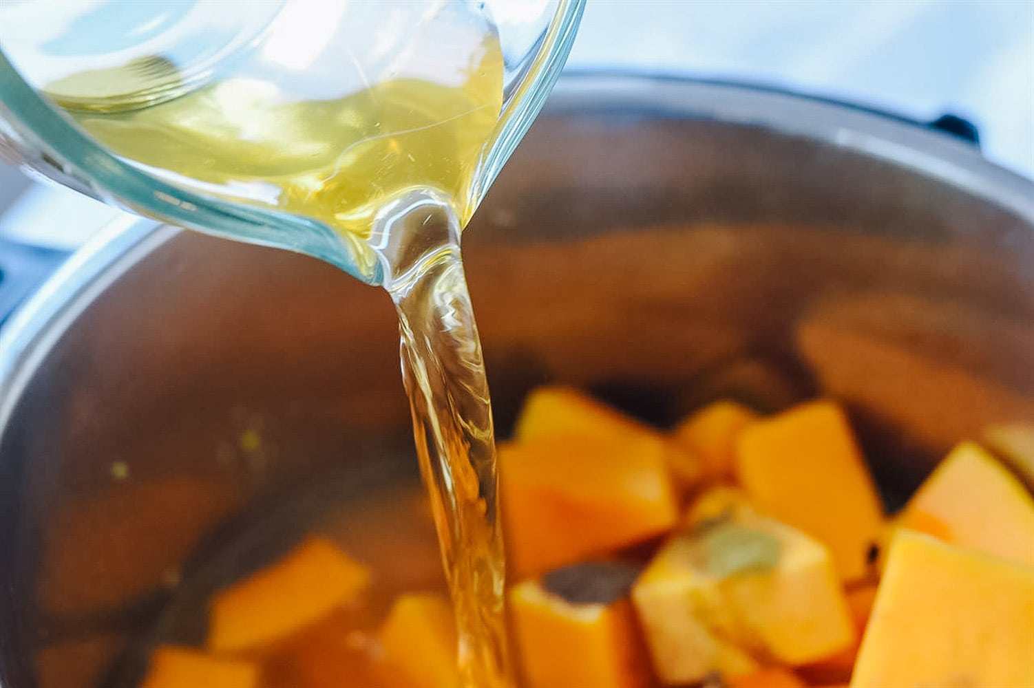 pouring apple juice into soup