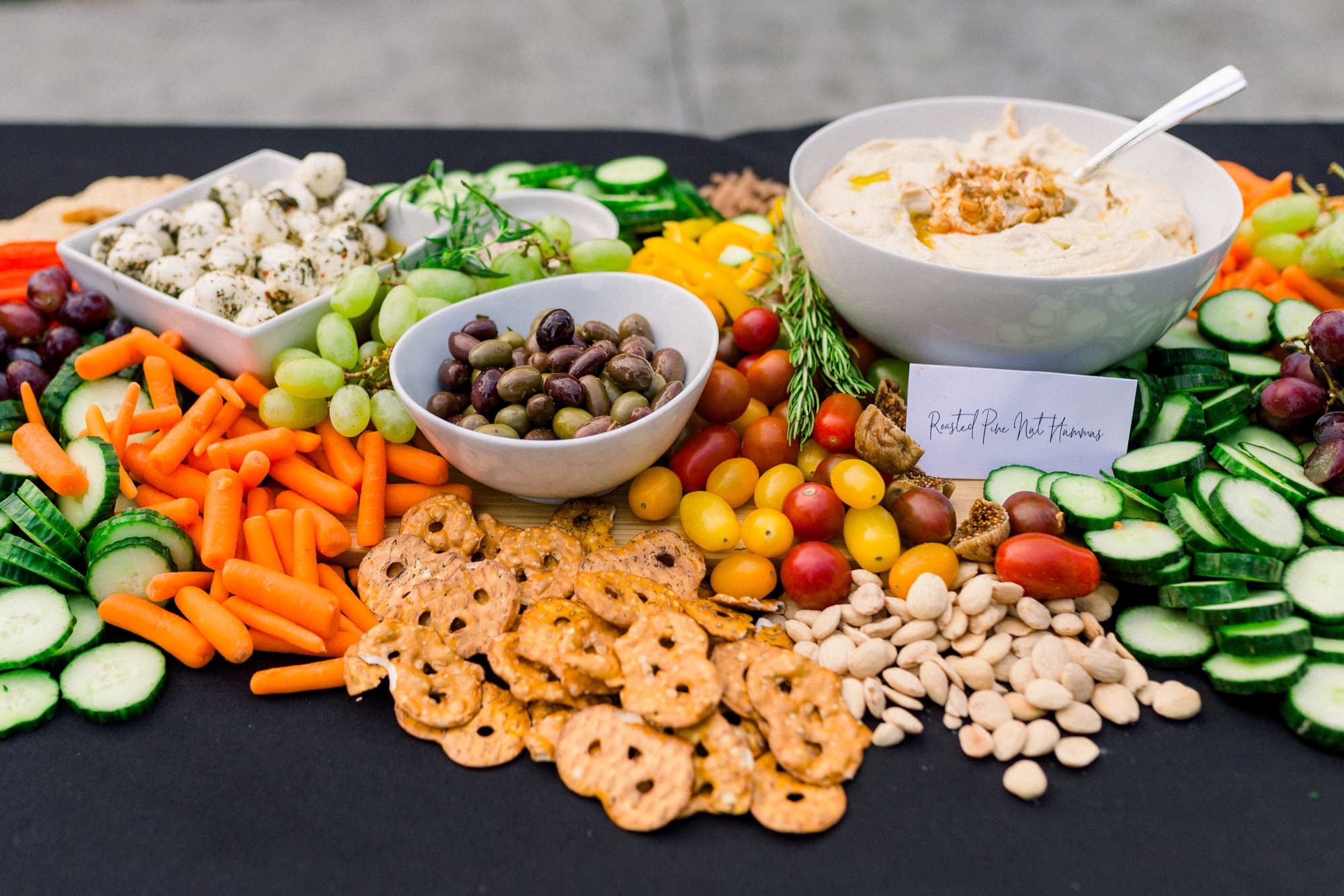 olives and hummus on a grazing table