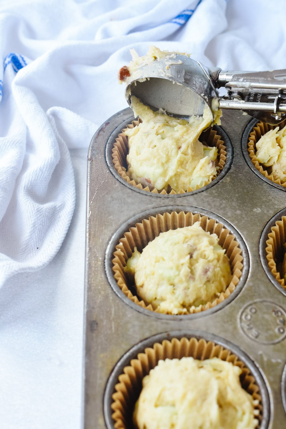 scooping muffin batter