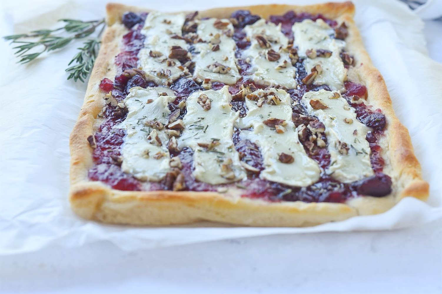 baked cranberry brie on parchment paper