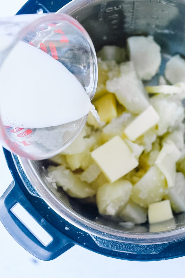 pouring milk into Instant Pot potatoes