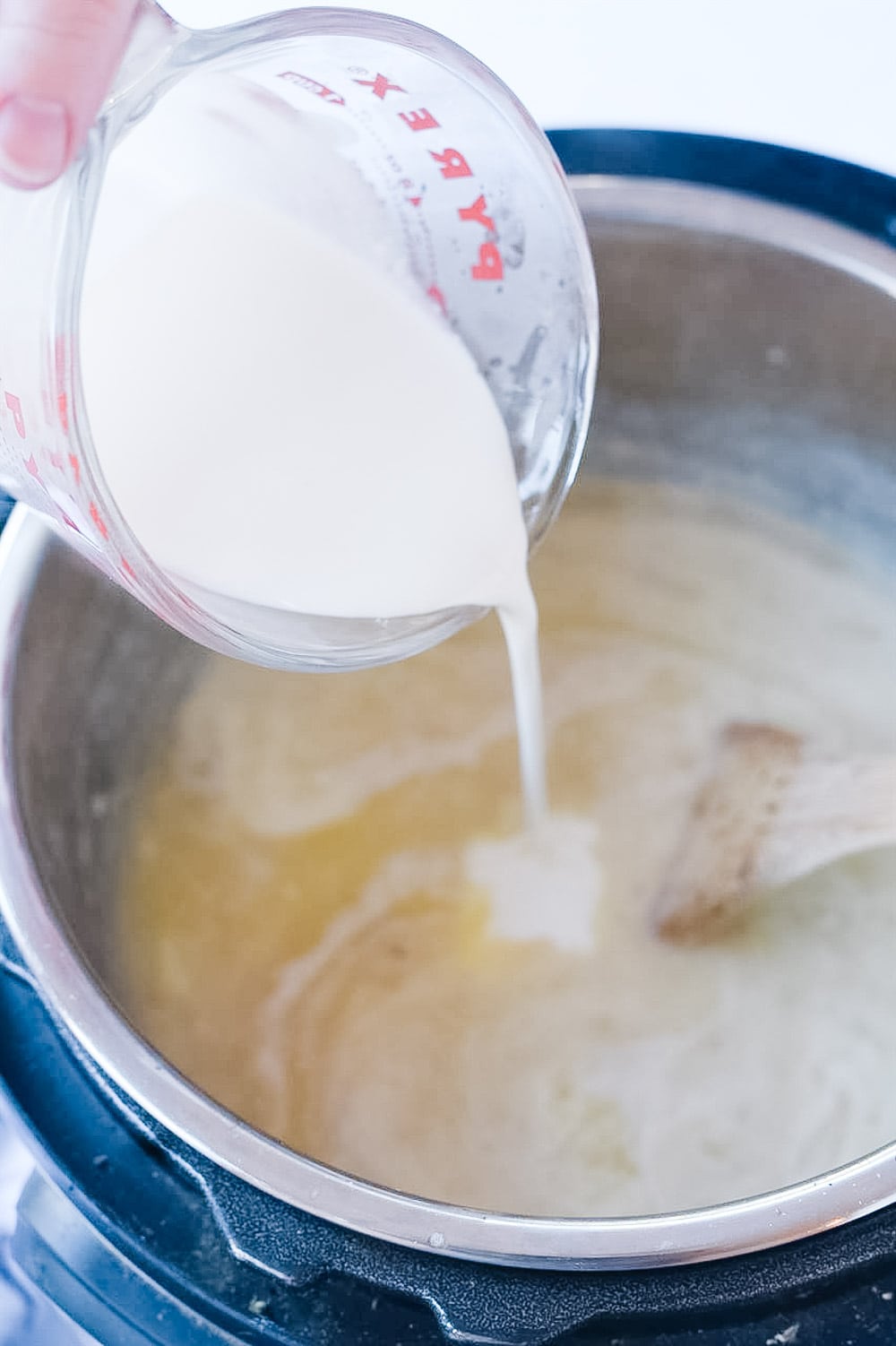 pouring cream into instant pot potato soup