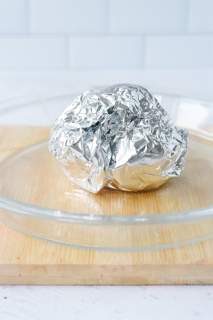 Roasted garlic covered with foil.