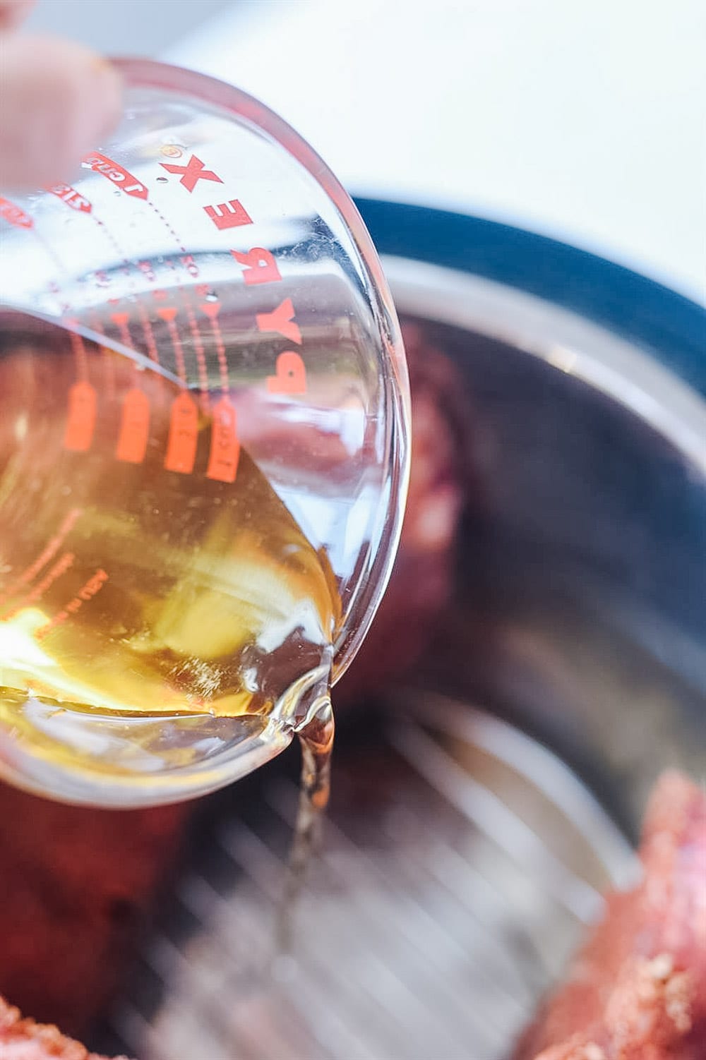 pouring apple juice into the instant pot