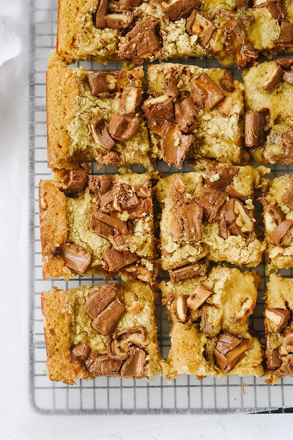 candy bar cake on cooling rack