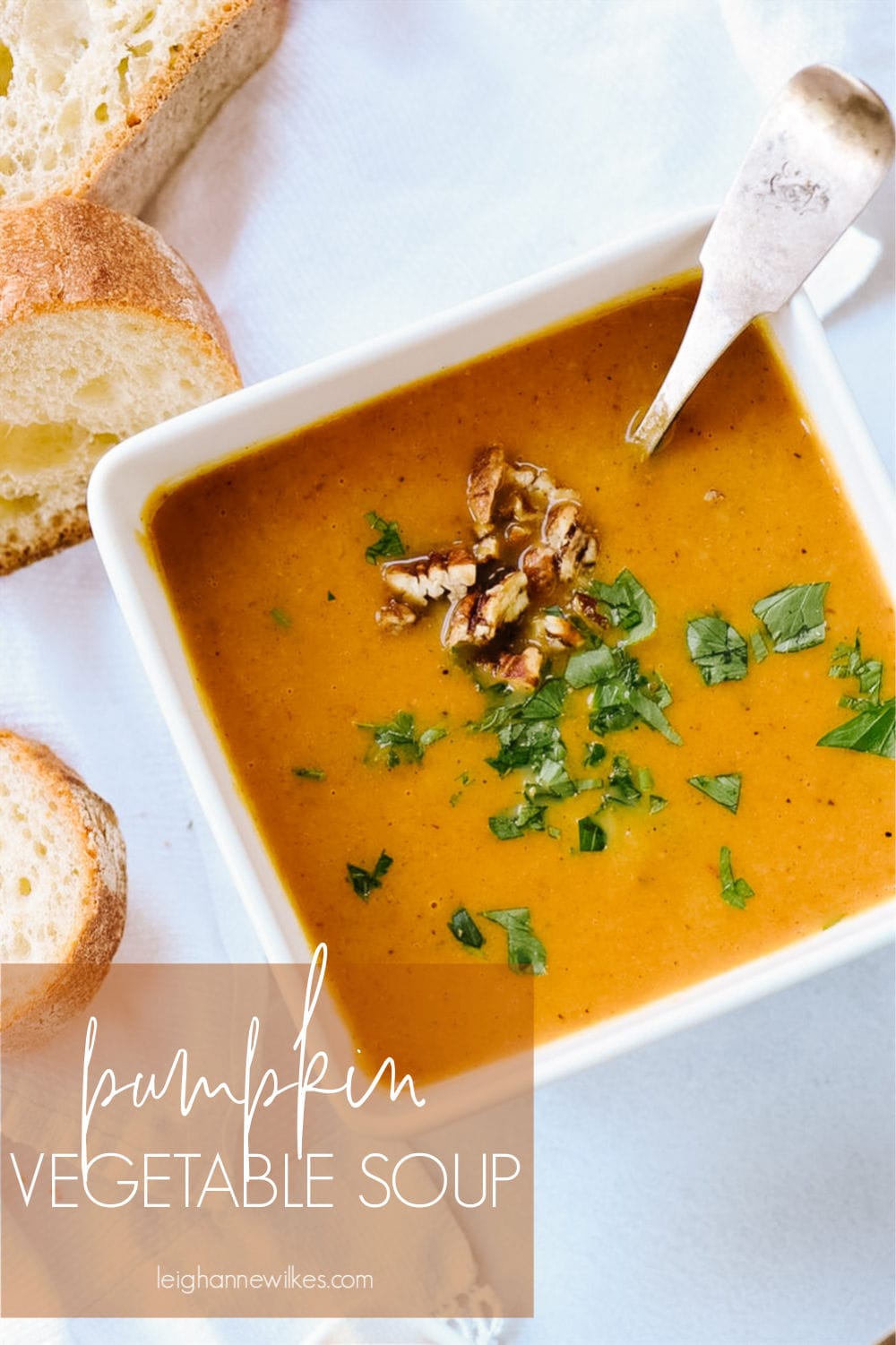 pumpkin soup in a bowl with parsley on top