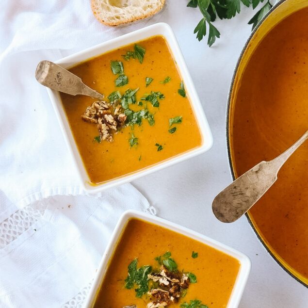 Two bowls of pumpkin vegetable soup