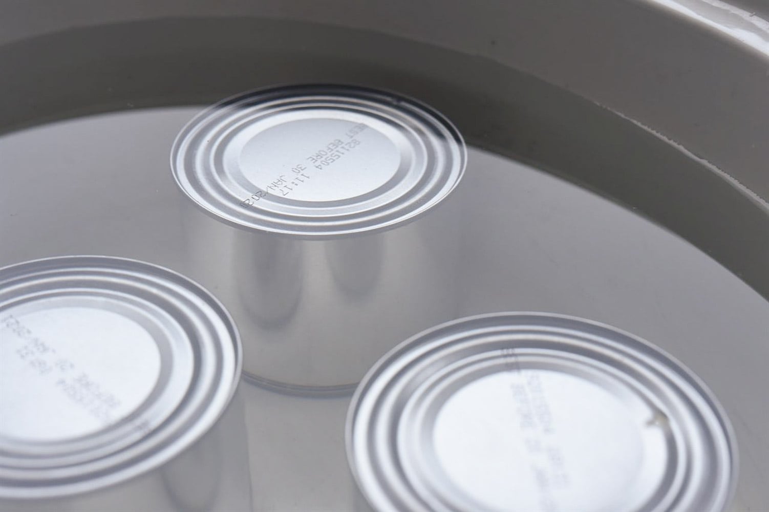 cans of sweetened condensed milk in a crock pot