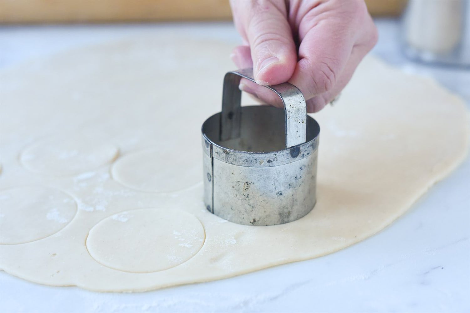 cutting out dough for pecan tassies