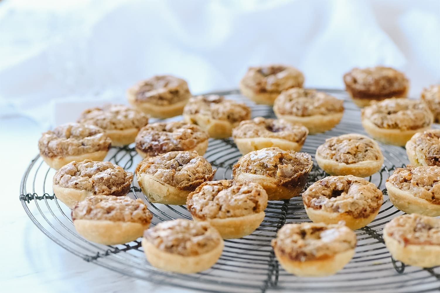 pecan tassies on a cooling rack.