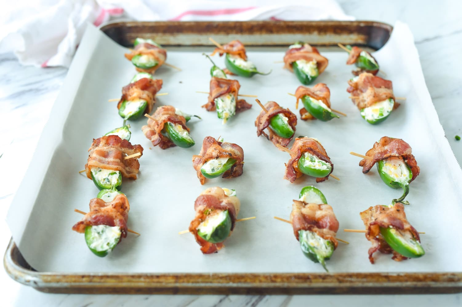 jalapeno poppers on a baking sheet