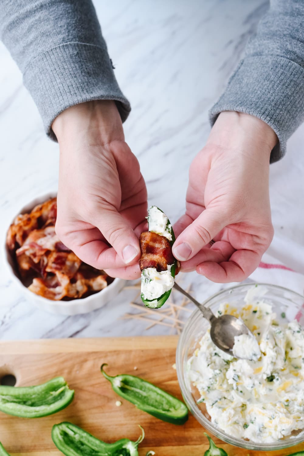 wrapping bacon on a jalapeno popper