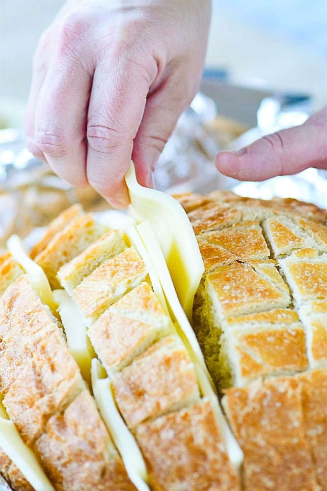 putting cheese into sliced bread