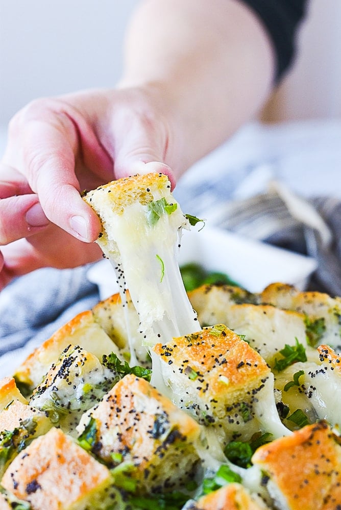 hand pulling bloomin onion bread