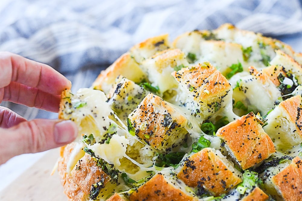 hand pulling bloomin onion bread