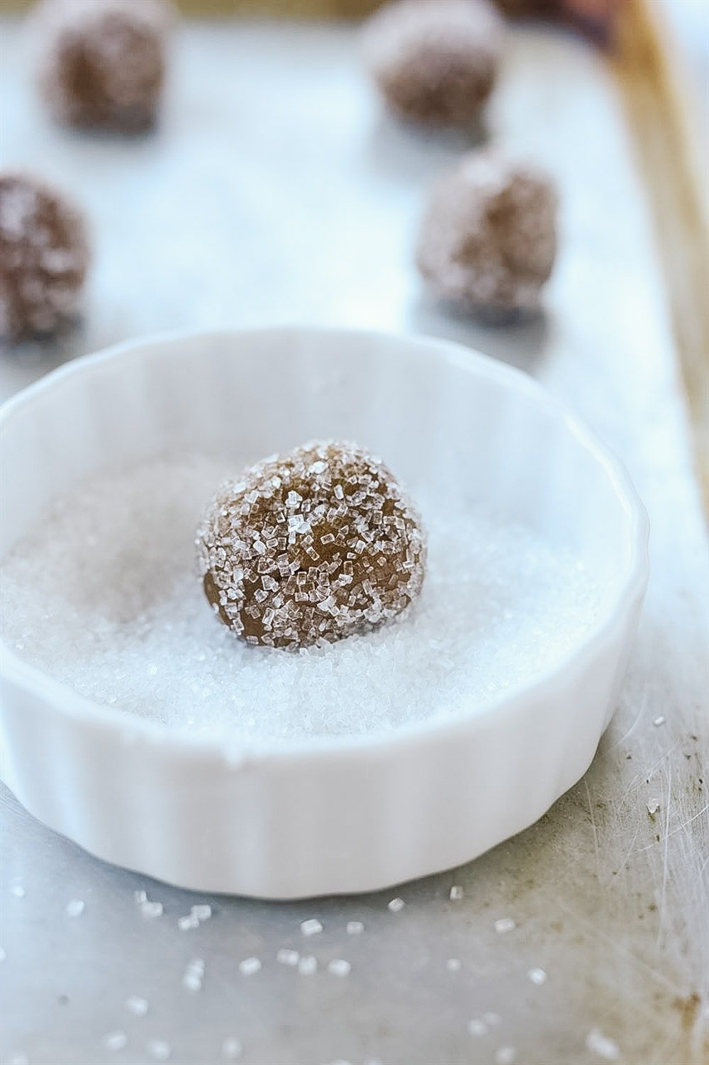 rolling gingersnaps in sugar