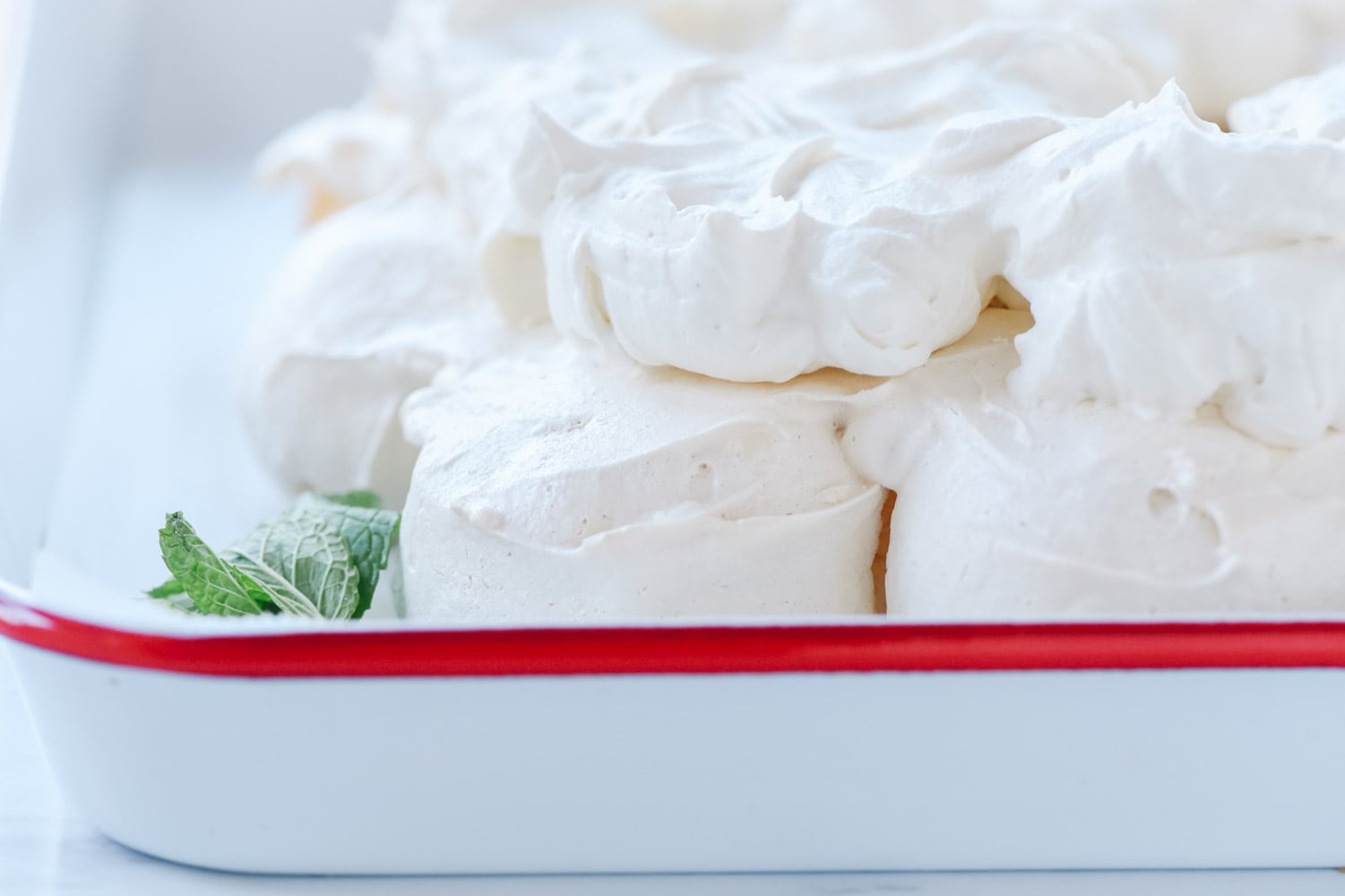 whipped cream on pavlova wreath