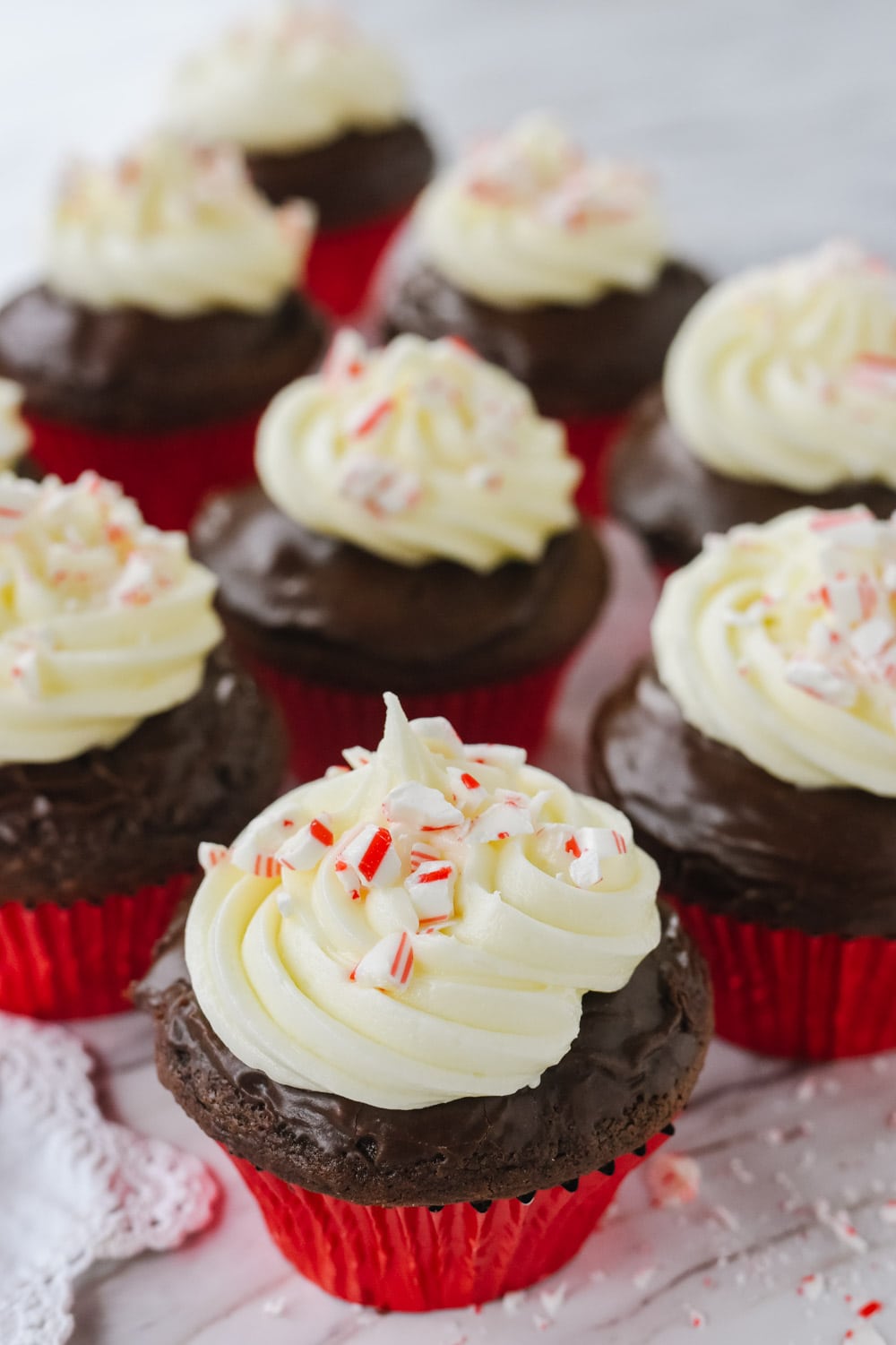 peppermint ganache cupcakes with candy cane on top