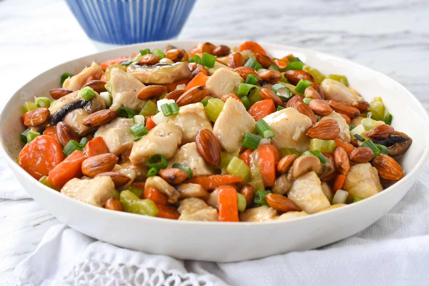 white bowl of almond chicken stir fry