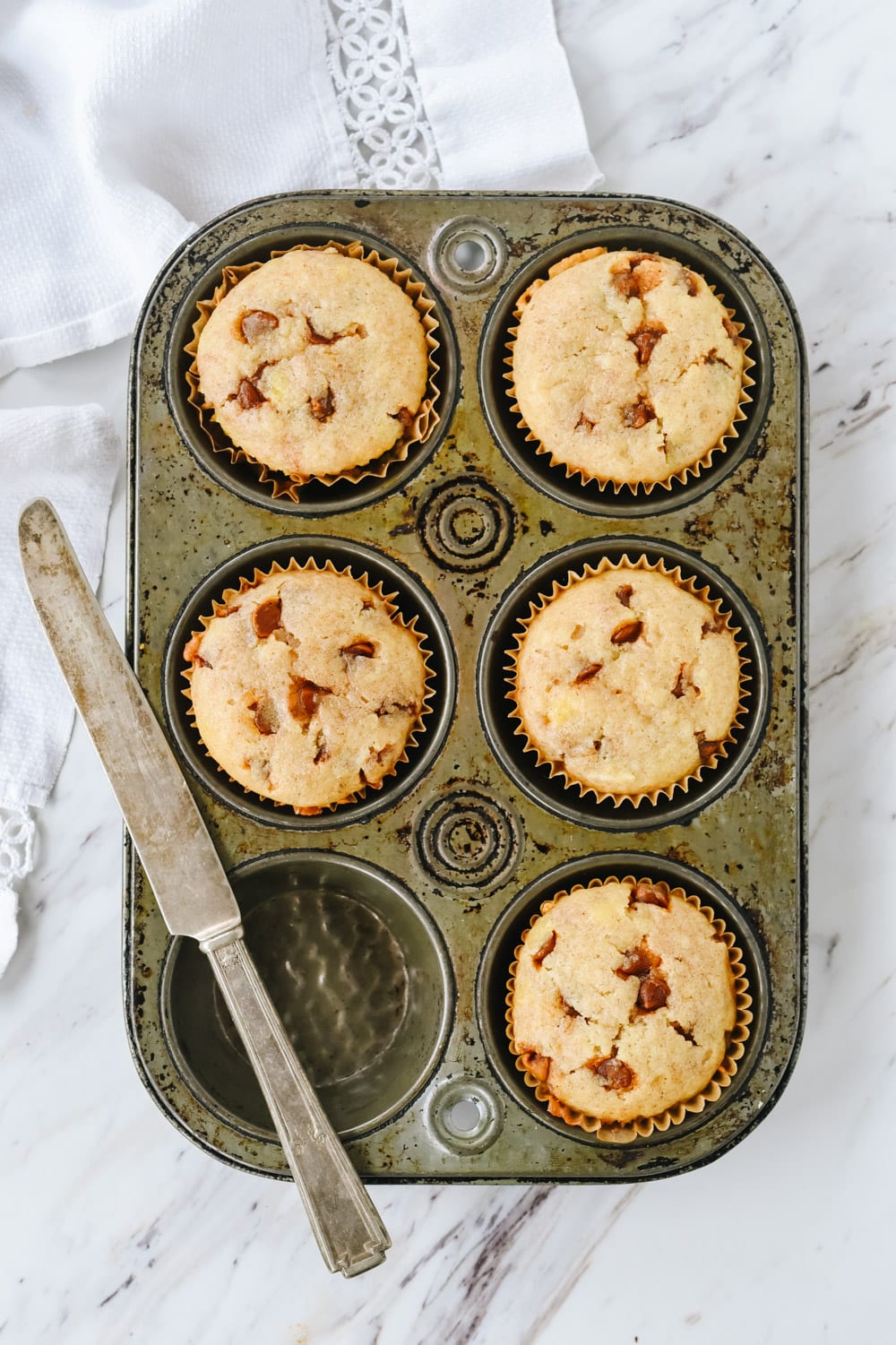 Banana Cinnamon Chip Muffins banana cinnamon muffins in a muffin tin