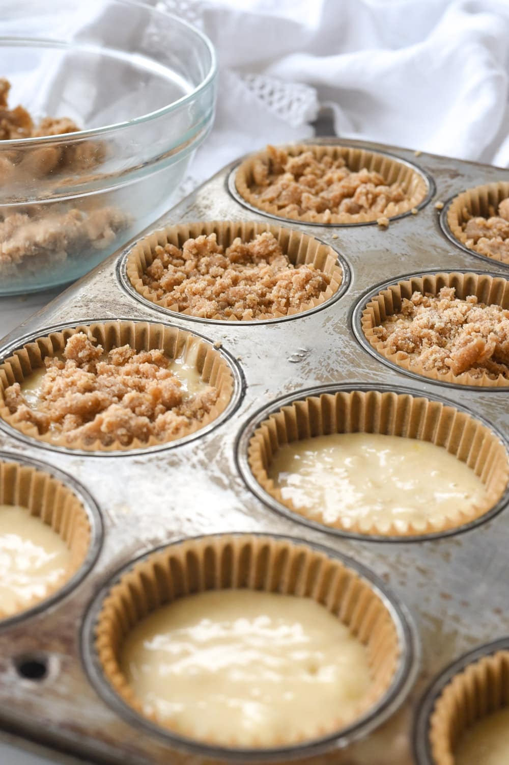 filling muffin tins with banana muffins