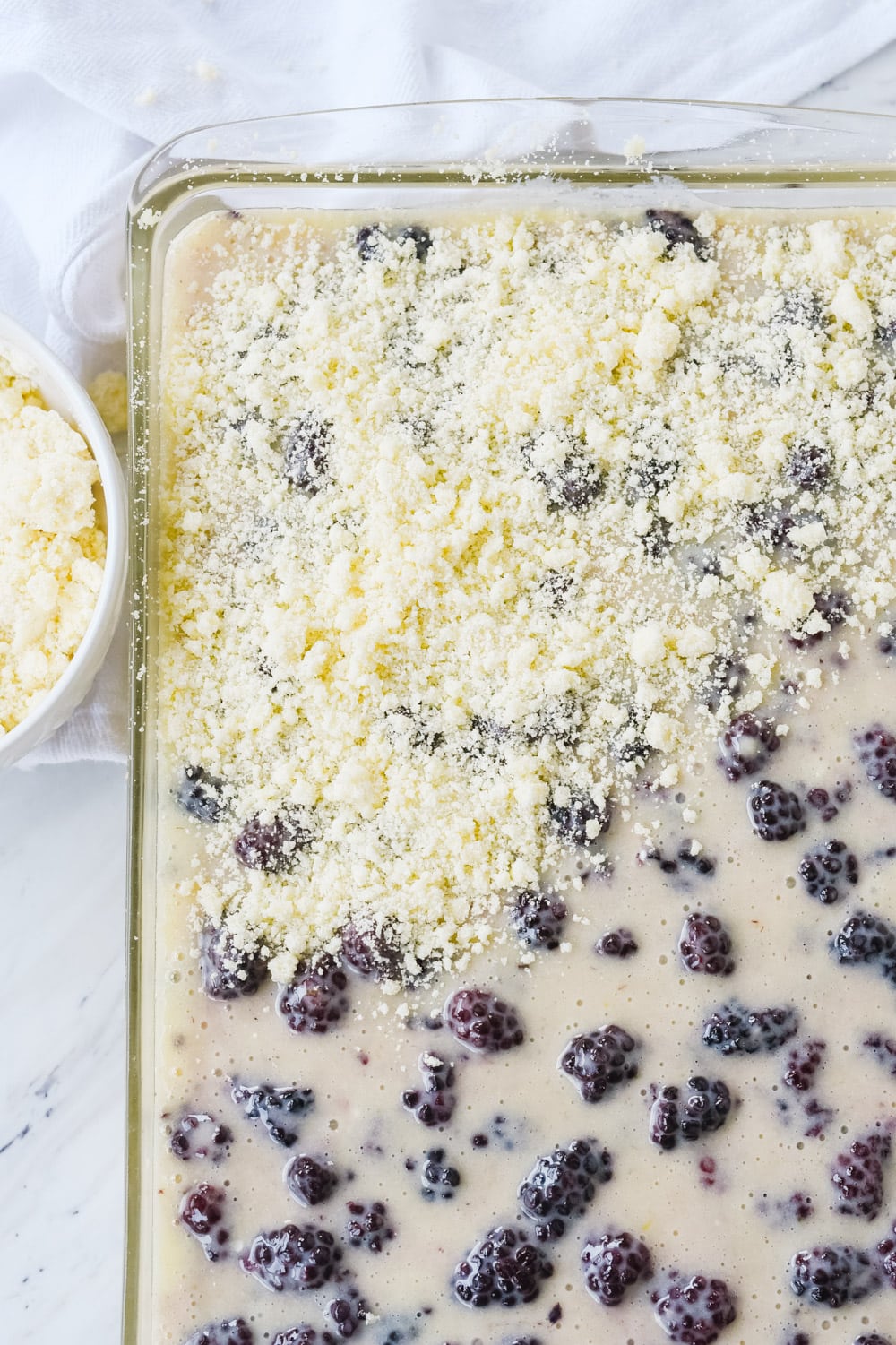 PUtting topping on blackberry pie bars