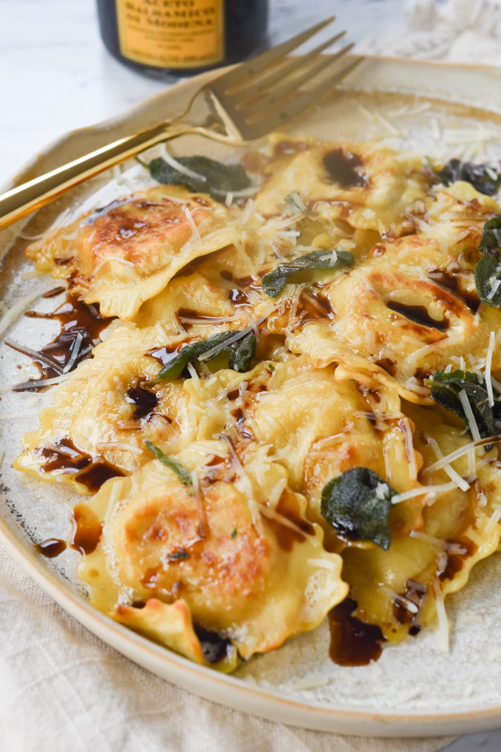 brown butter ravioli on a plate with sage