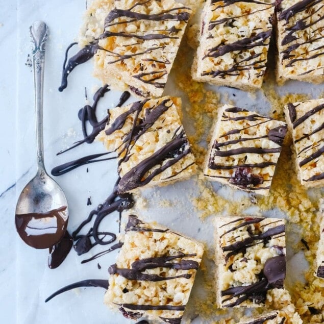 chocolate cherry rice krispie treats with chocolate drizzled on them