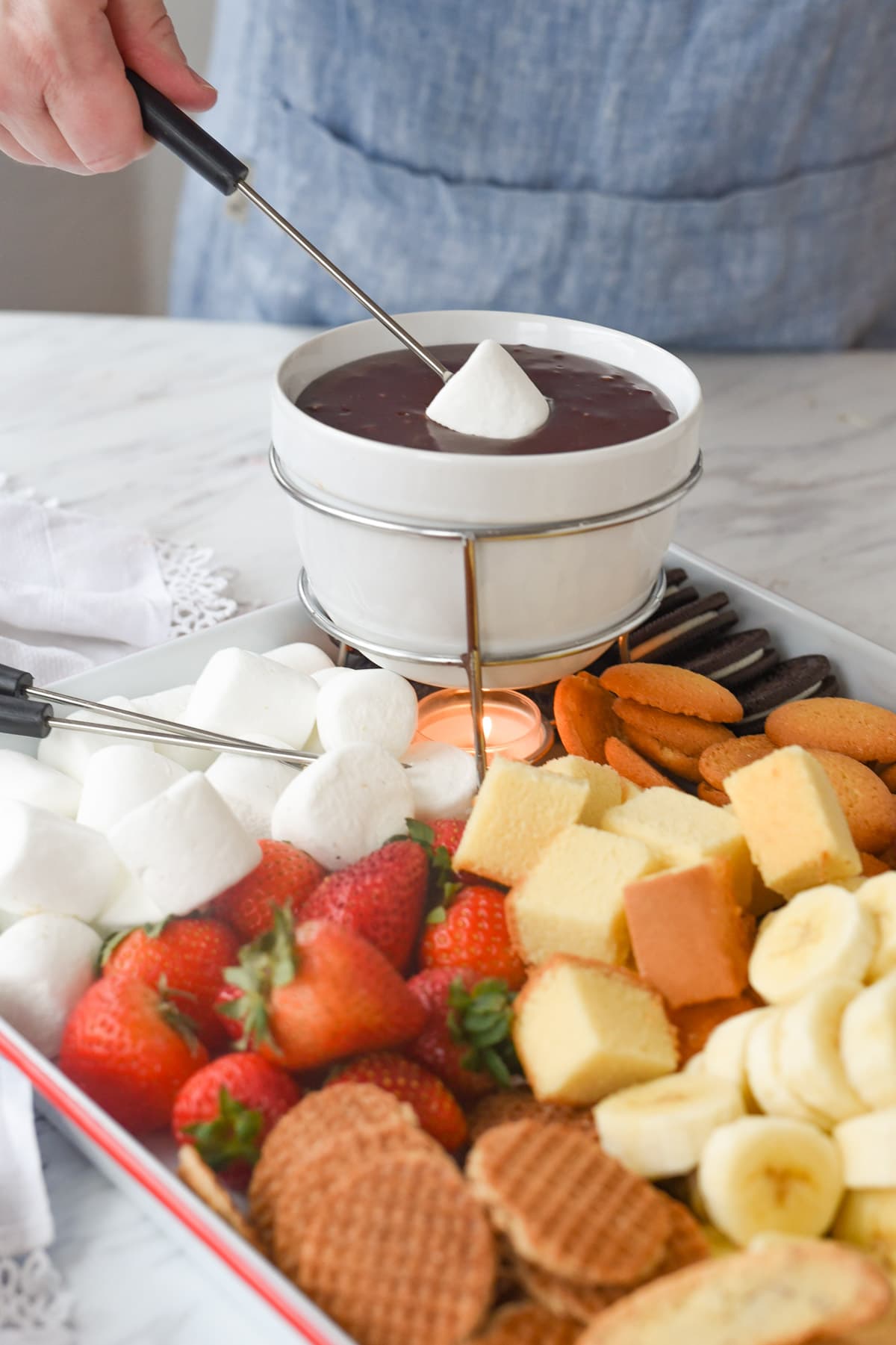 Dipping a Marshmallow into chocolate fondue