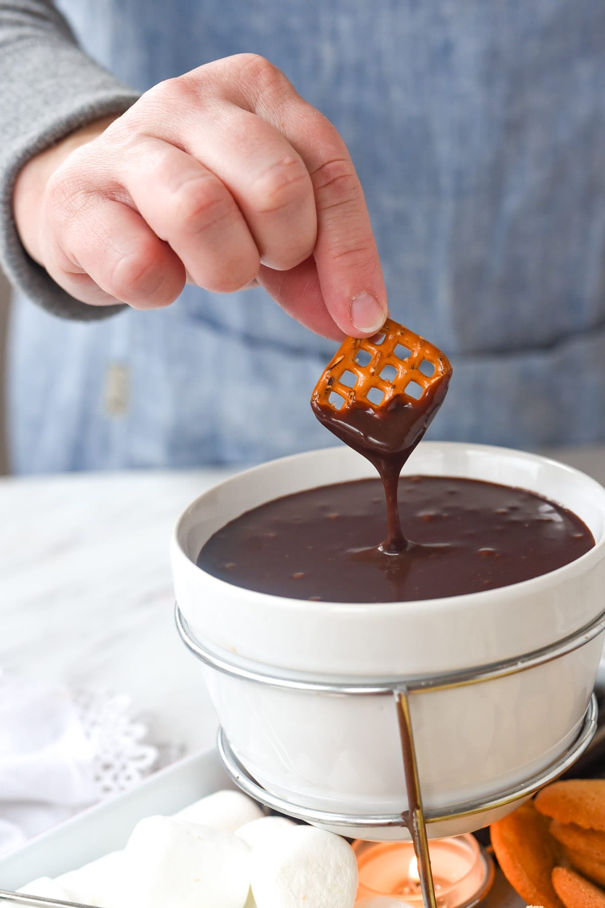 pretzel dipped into fondue