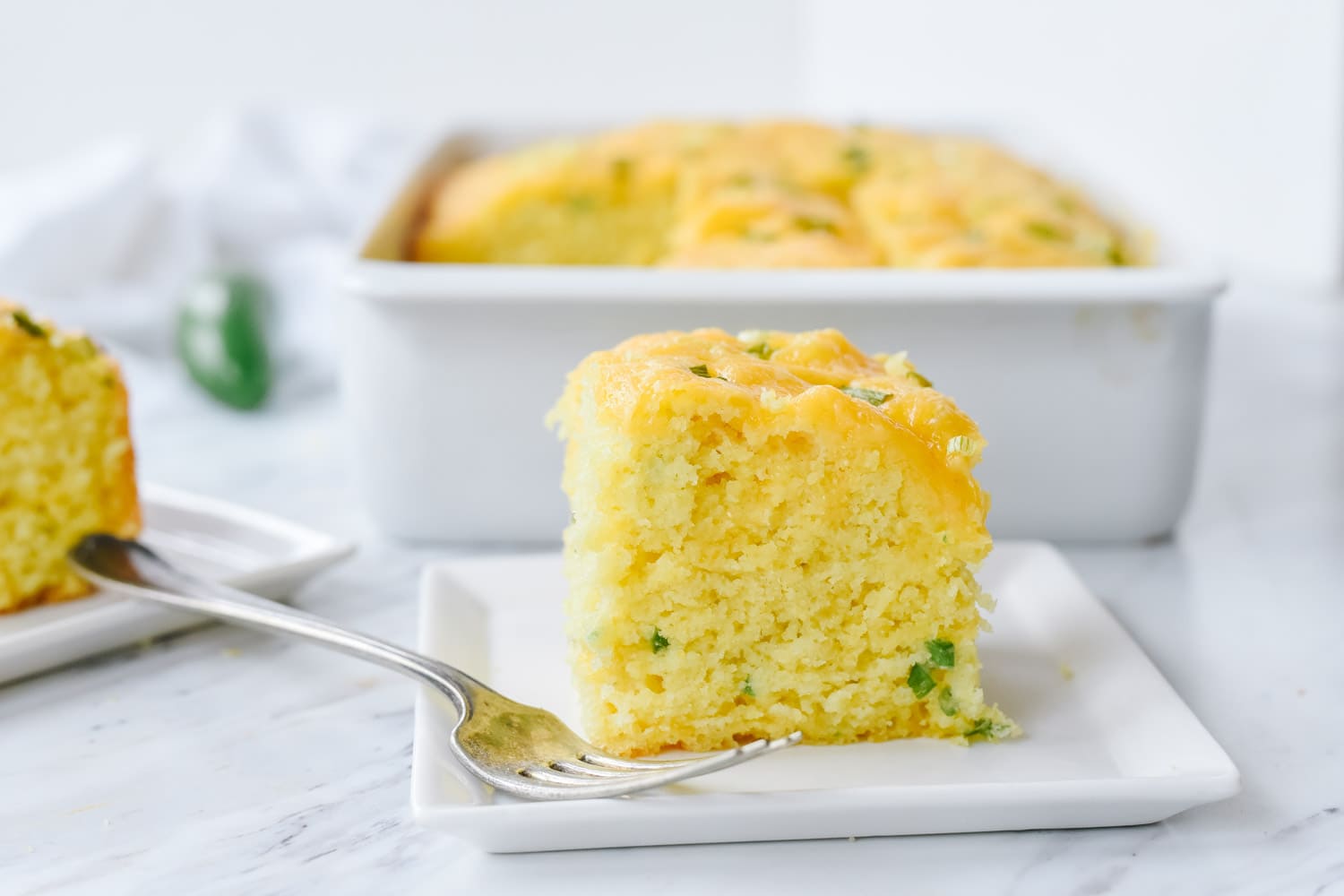 slice of jalapeno cornbread on a white plate.