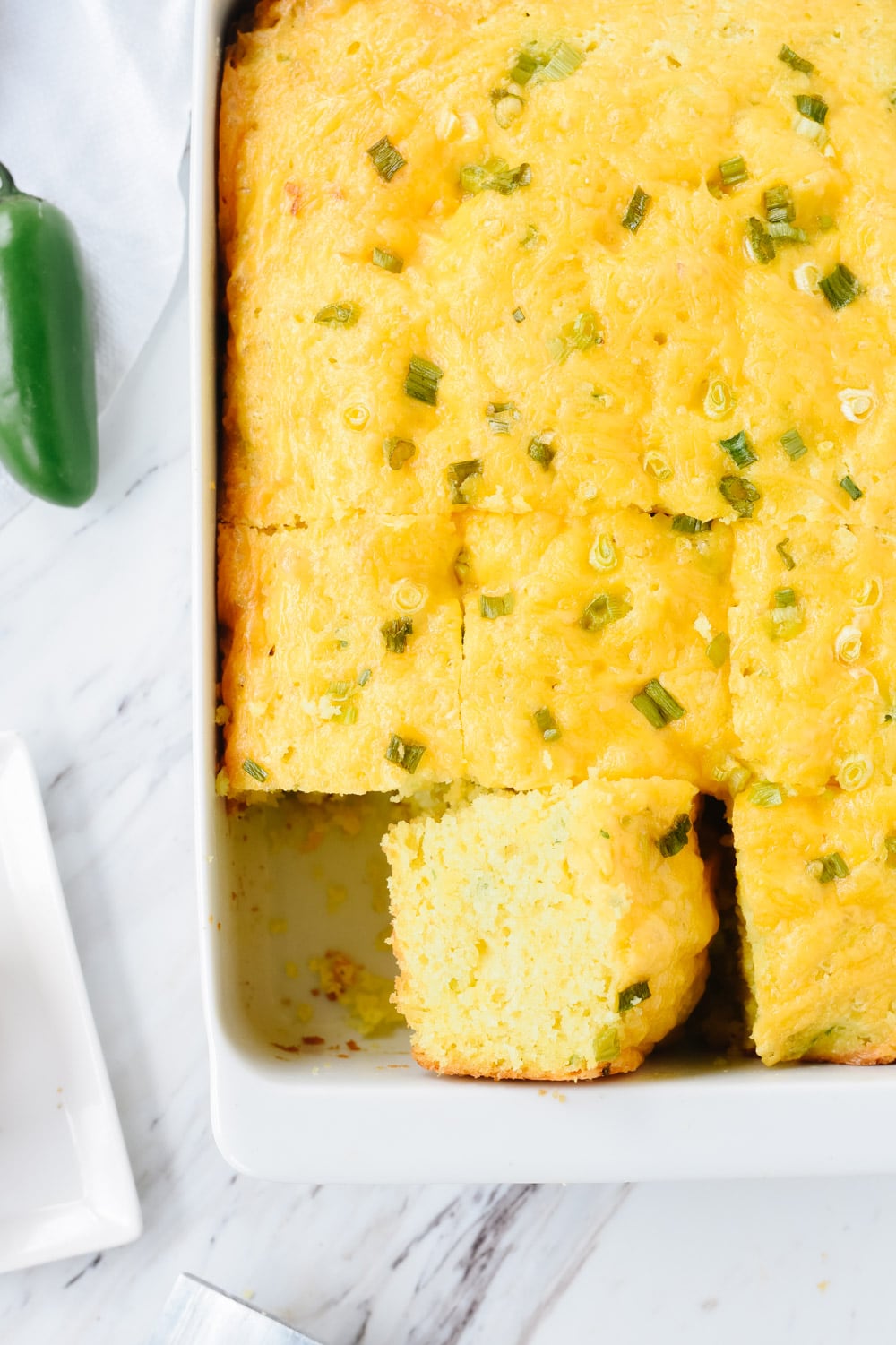 slice of jalapeno cornbread in a pan