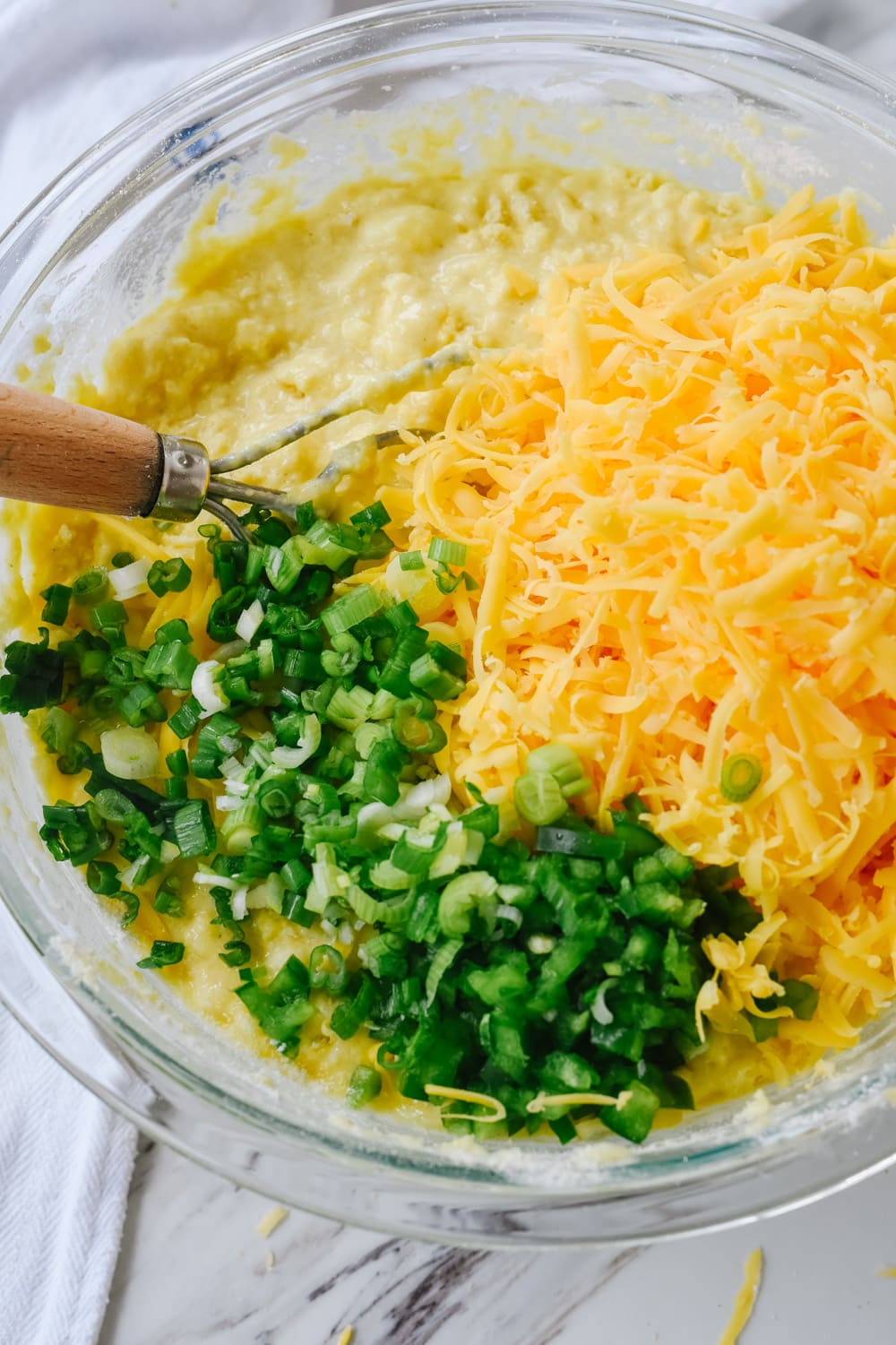 mixing jalapeno cornbread in a bowl.