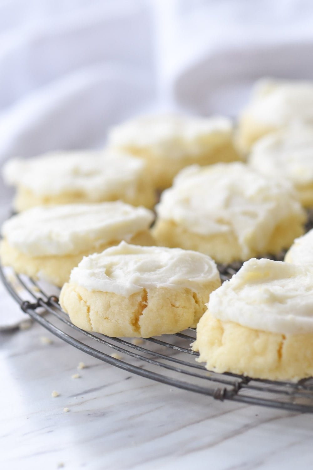 frosted cookies on a cooling rack