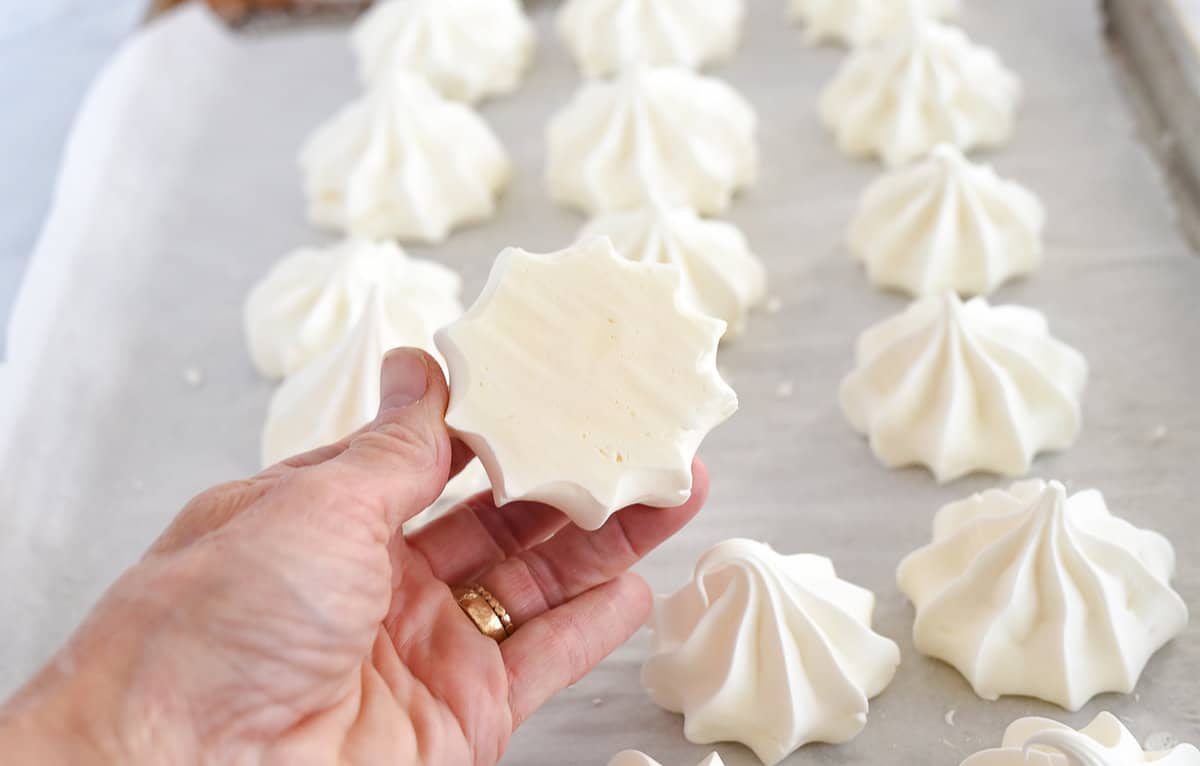 hand holding a baked meringue