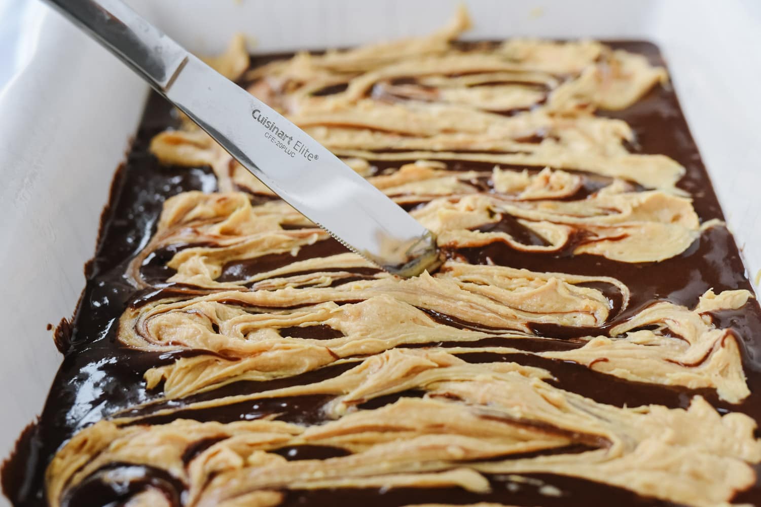 swirling peanut butter into brownie mix.