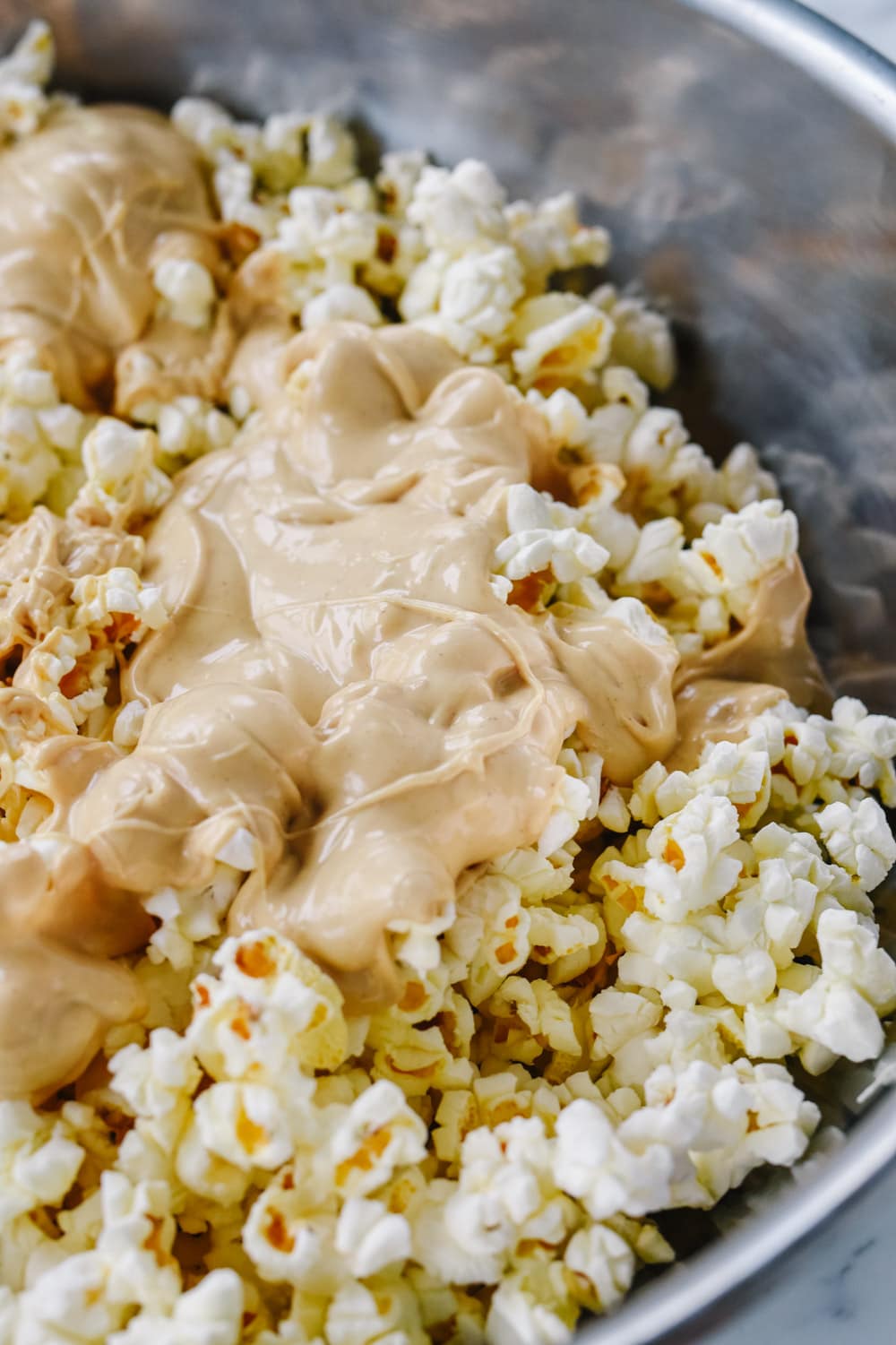 peanut butter mixture over popcorn