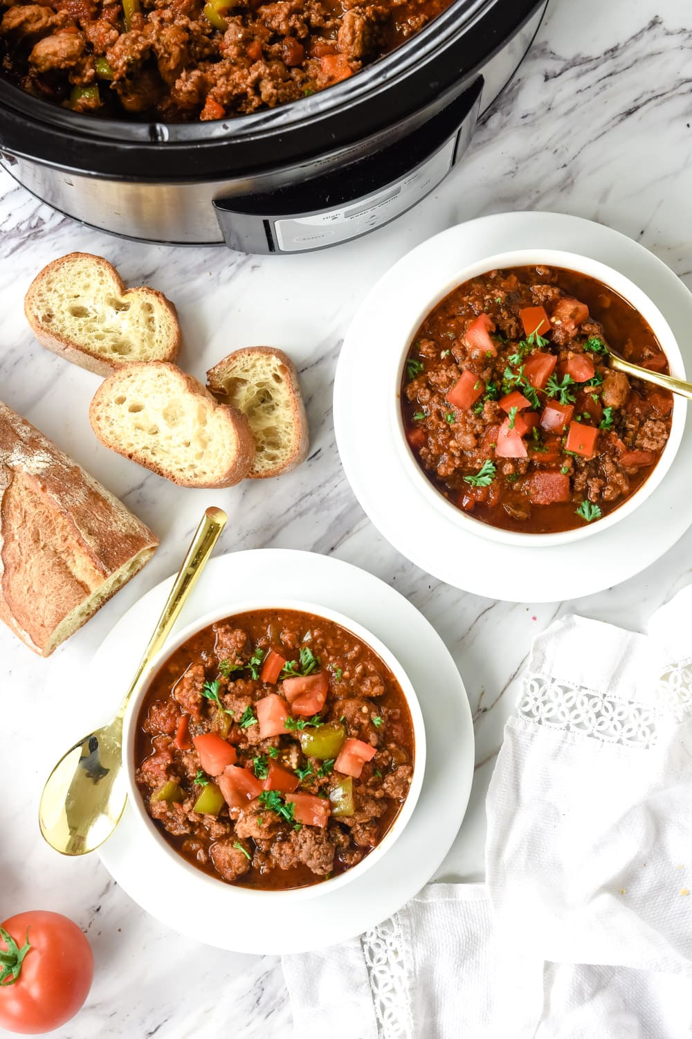 overhead shot of two bowls of sausage chili