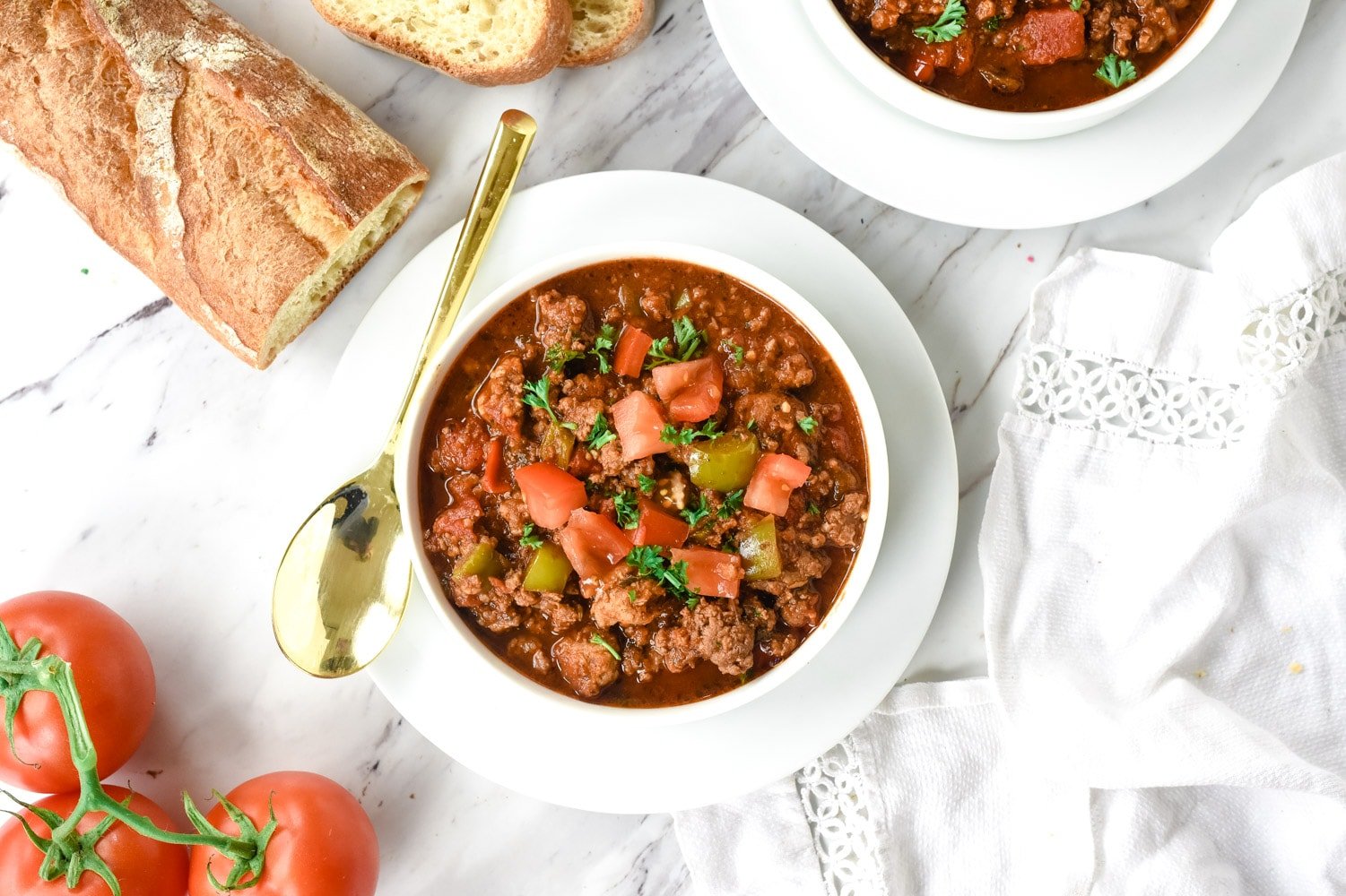 sausage chili in a white bowl