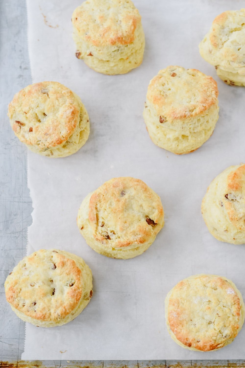 overhead shot of sour cream biscuits on a baking sheet