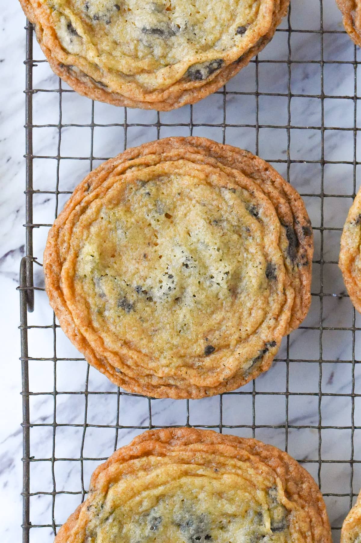 close up of a crinkle chocolate chip cookie on a cooling rack