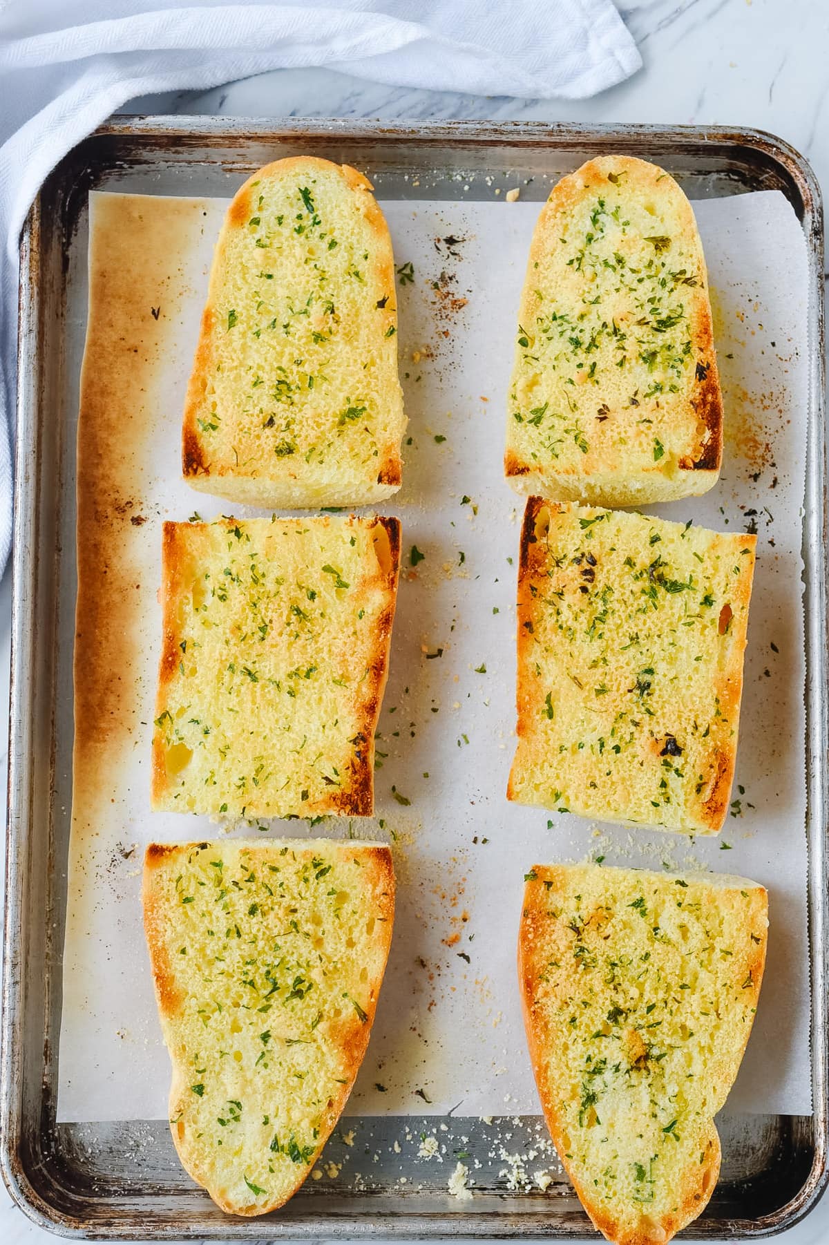 toasted garlic bread on parchment paper