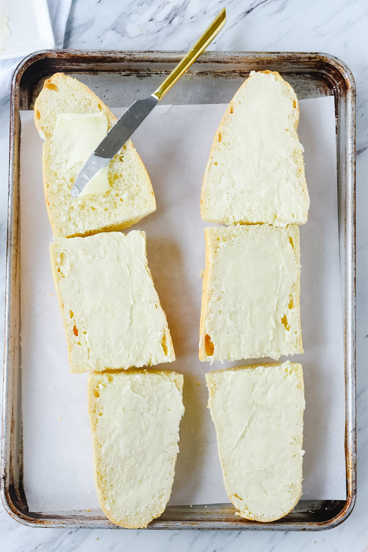 buttering garlic bread